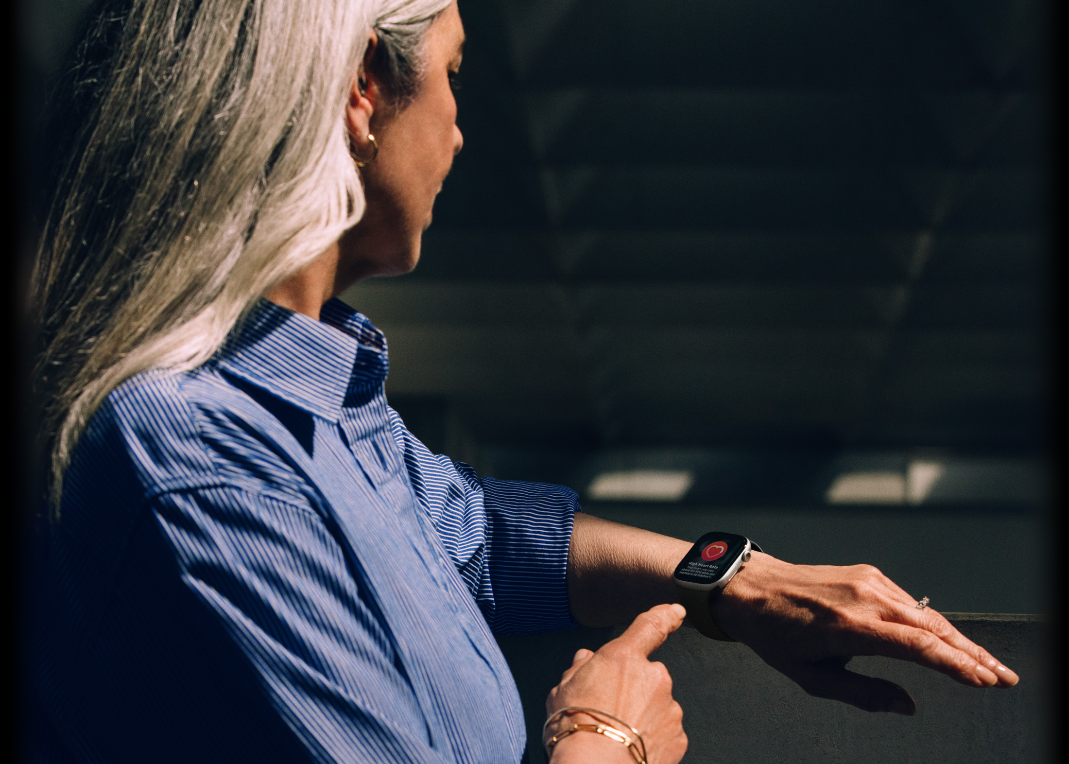 A person reads a heart rate notification on their Apple Watch Series 11