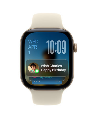 Apple Watch Series 11, Emas Rose dengan tali jam pink lembut, wajah jam menampilkan tanggal di kiri atas, waktu di kanan atas, dan widget Pesan di bagian bawah