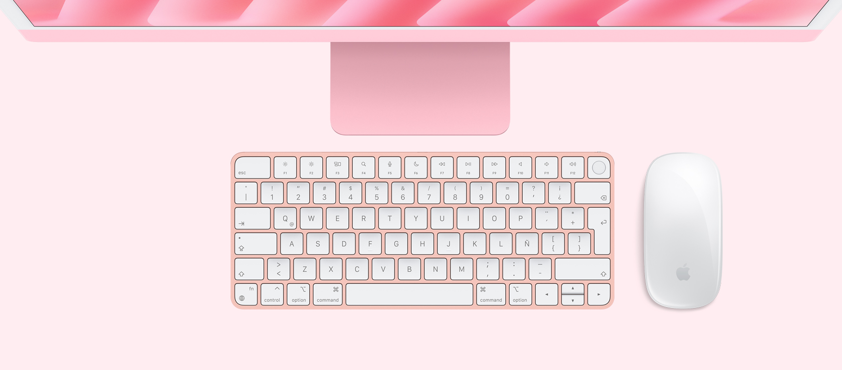Vista panorámica de una iMac rosa con mouse y teclado a juego