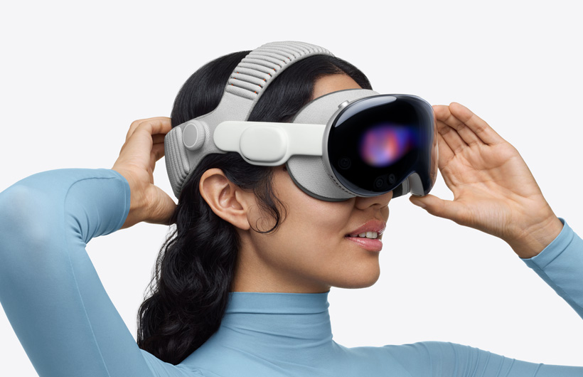 شخص يضع Apple Vision Pro على وجهه ويجلس على أريكة في غرفة الجلوس، وأمامه شاشة كبيرة إلى جانب شاشتين أصغر حجماً، وكل واحدة منها تعرض فعالية رياضية مختلفة. وفي أسفل الشاشة الكبيرة، تظهر نافذة اختيار كُتبت عليها عبارة إضافة المزيد
