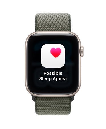 Apple Watch SE 3, корпус з алюмінію, колір «зіркове сяйво», можливе сповіщення про апное вві сні, рожеве серце в білій рамці, правий бік корпусу, коронка Digital Crown, спортивний браслет кольору «лісова зелень»