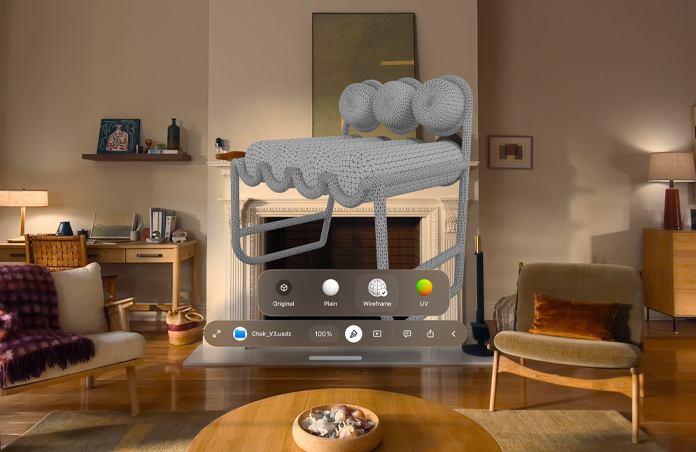 عرض على Apple Vision Pro يظهر نافذة إشعار من ميزة "المعاينة السريعة" تشير إلى ملف USDZ لمقعد، ويظهر هيكل شبكي للمقعد خلف النافذة